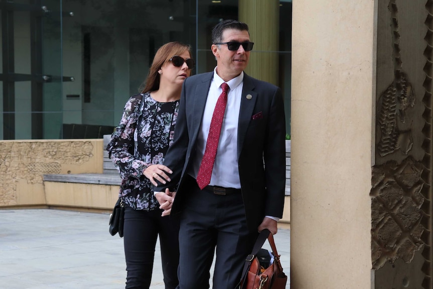 Andrew Antoniolli arriving at court with his wife in hand.