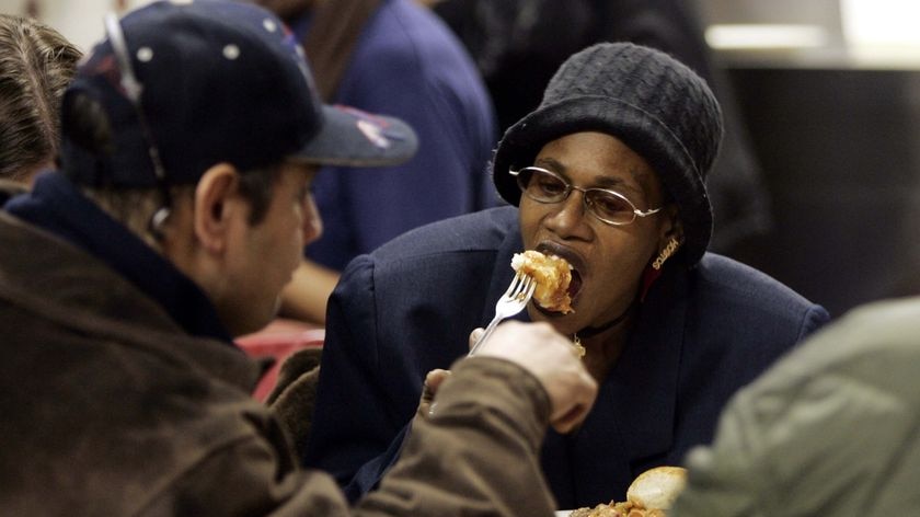 A woman eats in a soup kitchen in the Bronx
