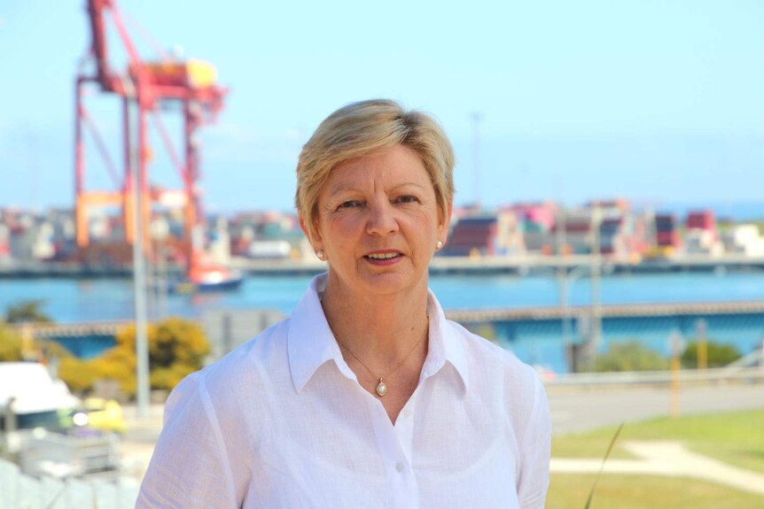 A close up shot of Kim Dravnieks with the Fremantle Port in the background.