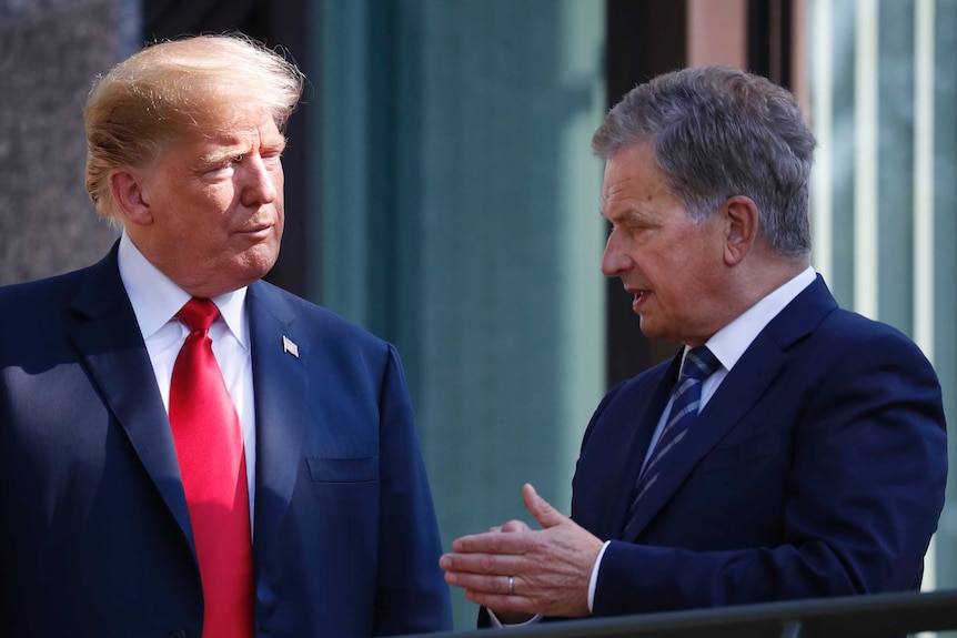 Donald Trump looks on as he talks to Sauli Niinisto