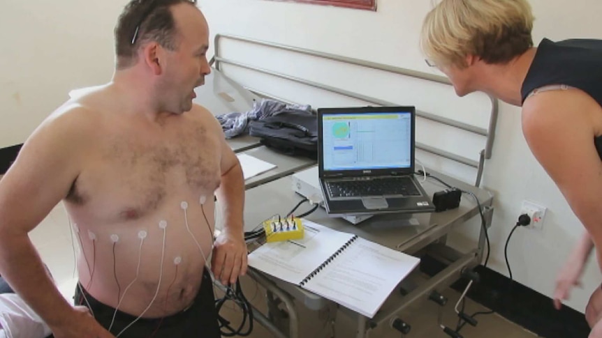 Professor John Fraser and Professor Kath Maitland test their modified breathing device.