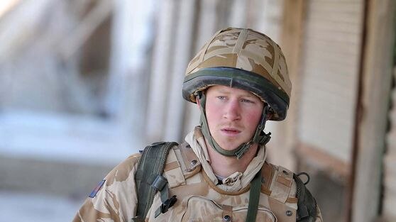 Britain's Prince Harry patrols through the deserted town of Garmisir
