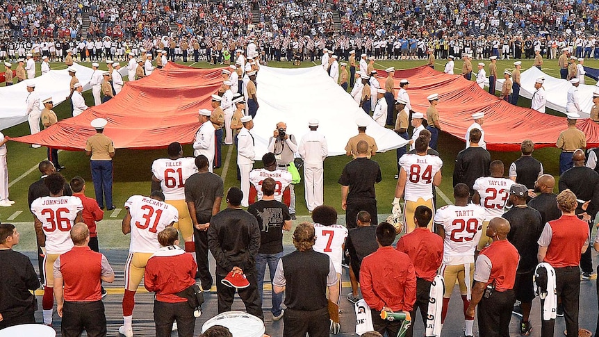 Colin Kaepernick kneels during the national anthem