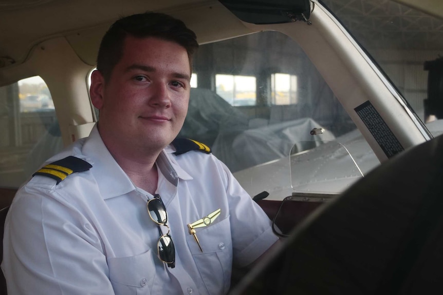 A learner pilot sits in the cockpit of a small plane