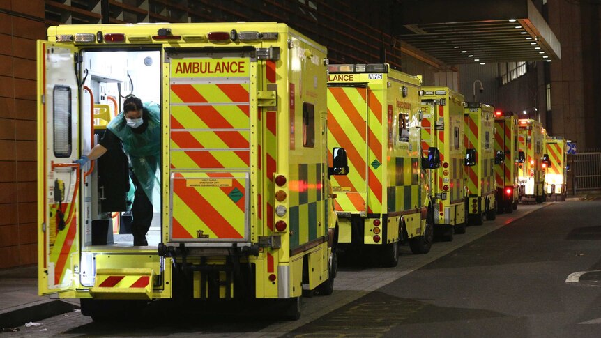 A row of ambulances are parked outside the Royal London Hospital