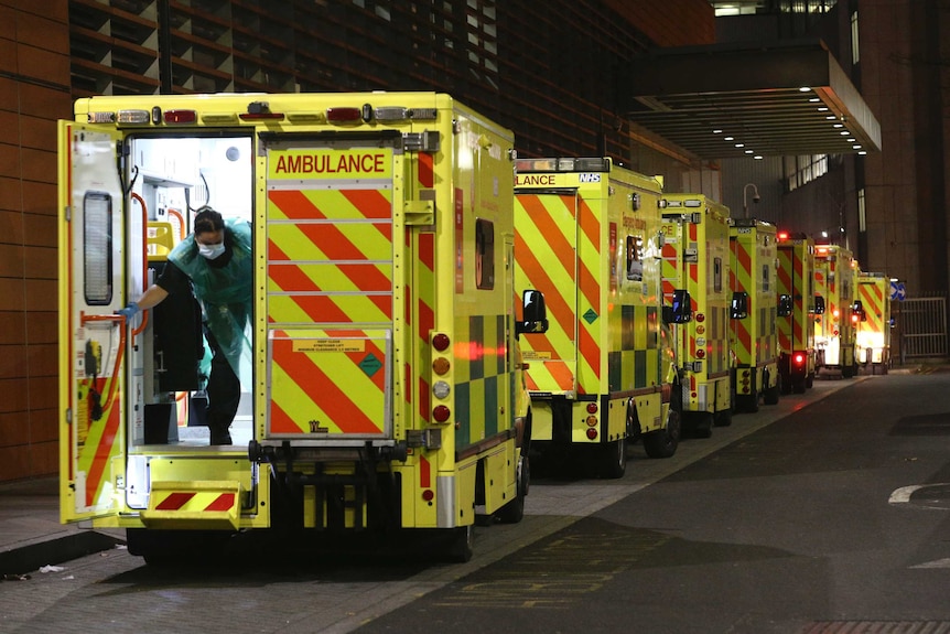 A row of ambulances are parked outside the Royal London Hospital