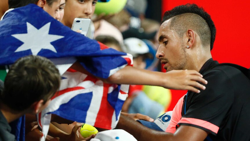 Nick Kyrgios signs autographs for fans at Australian Open