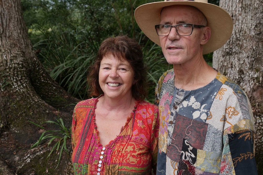Death doula Leonie Watson, pictured with partner Chuck Reimal, in a bush setting.