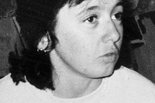 Old black and white photo of a woman, not smiling, dark hair, Michelle Lewis.