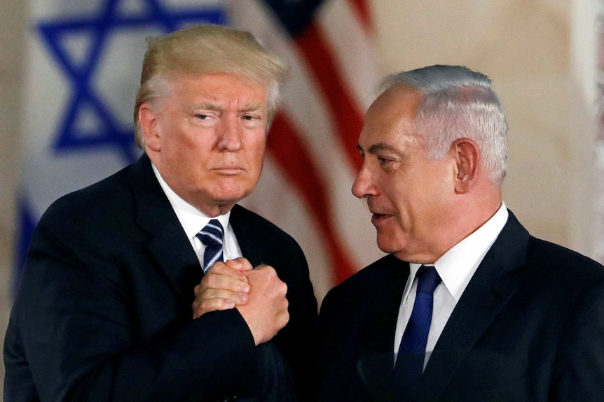 US President Donald Trump shakes hands with Israel's Benjamin Netanyahu