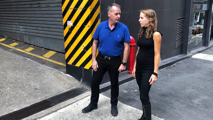 Cyclist James Stevenson and Bicycle Queensland CEO Anne Savage stand in the Brisbane laneway.