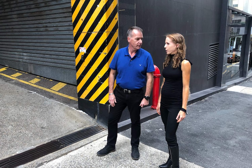 Cyclist James Stevenson and Bicycle Queensland CEO Anne Savage stand in the Brisbane laneway.