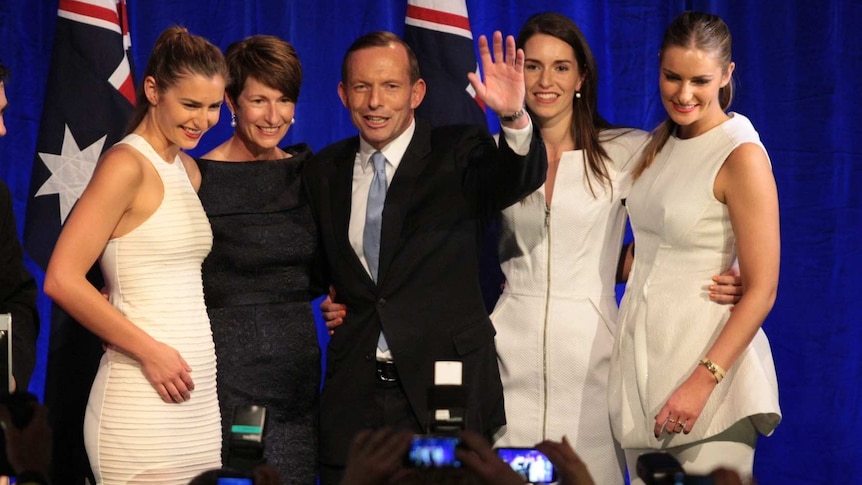 Tony Abbott celebrates on stage with wife Margie and their daughters.