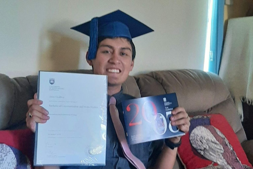 Jessie Godfrey with his diploma at home.