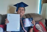 Jessie Godfrey with his diploma at home.