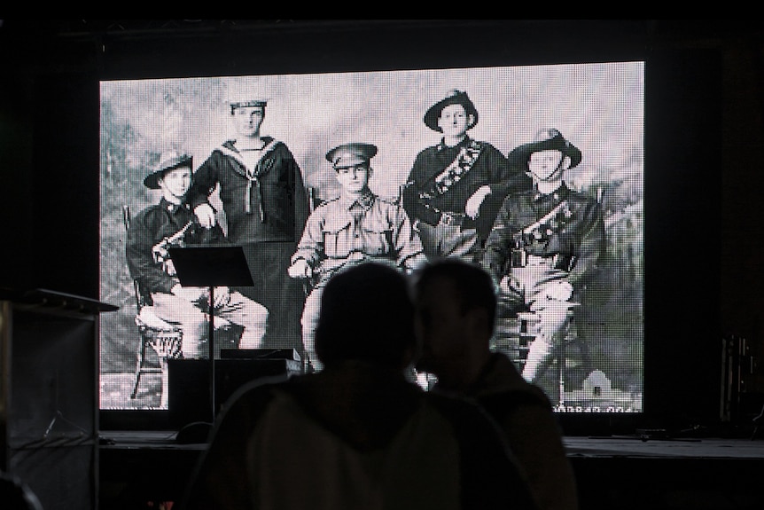 LED screens displaying soldiers at a dawn service in Newcastle on Anzac Day 2014