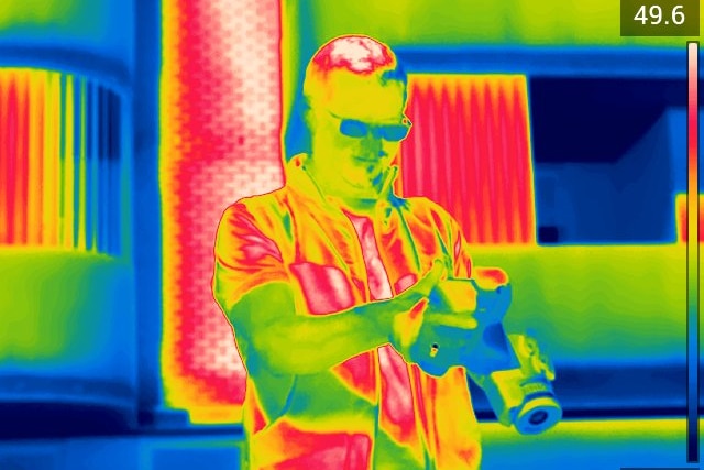 Infrared image of Sebastian Pfautsch holding camera.