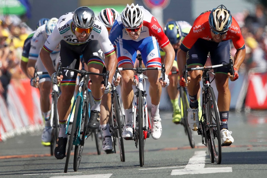 Peter Sagan (L), Sonny Colbrelli (R), Arnaud Demare sprint on Tour de France stage two, 2018.