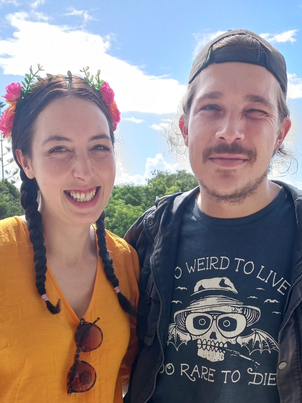 Woman and man posing for a photo smiling.