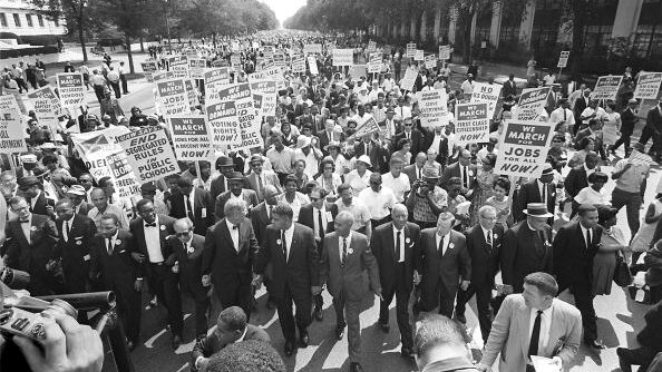 Martin Luther King Jr. marches alongside thousands of civil rights activists in Washington DC