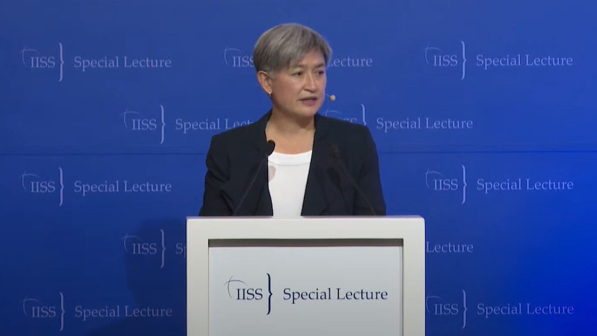 Close up of woman speaking at podium.