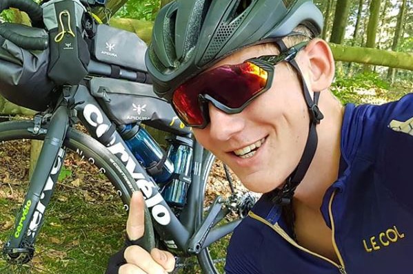 Charlie Condell with the bike he has ridden around the world with, before it was stolen in Townsville.