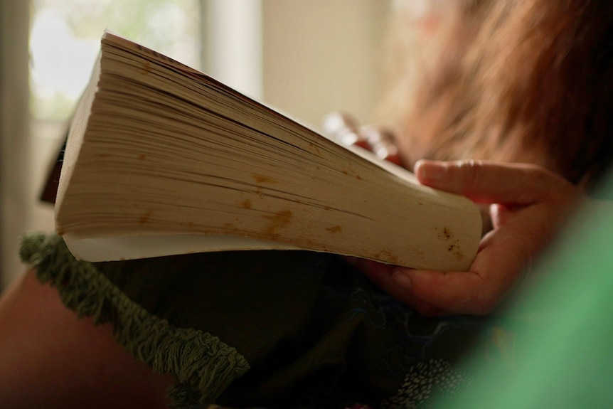 Unidentified person holding open book