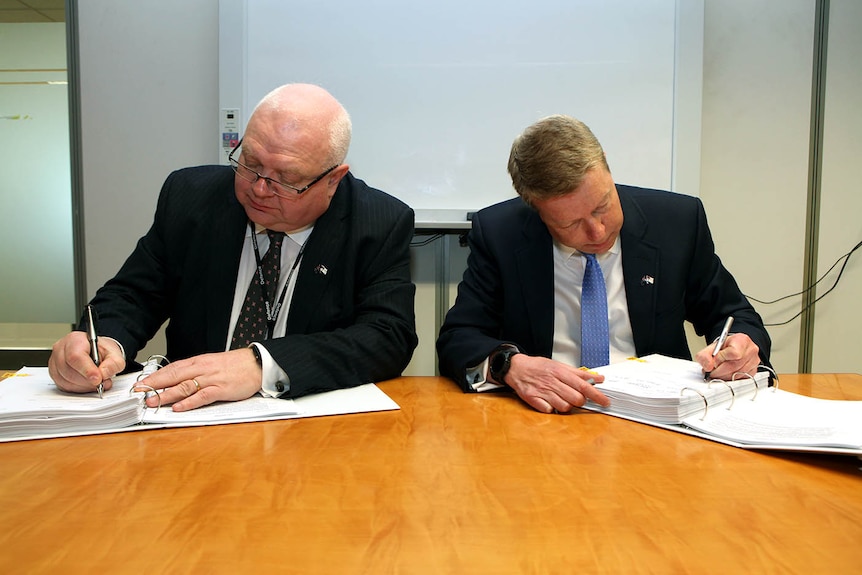 Paddy Fitzpatrick and Nigel Stewart co-sign documents
