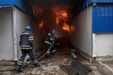 firefighter spraying water after Sloviansk shelling