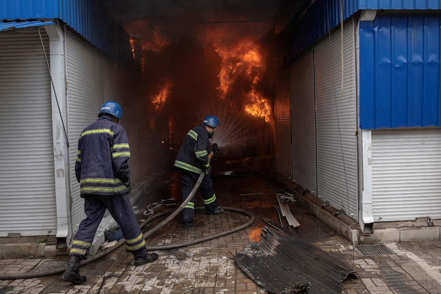 firefighter spraying water after Sloviansk shelling