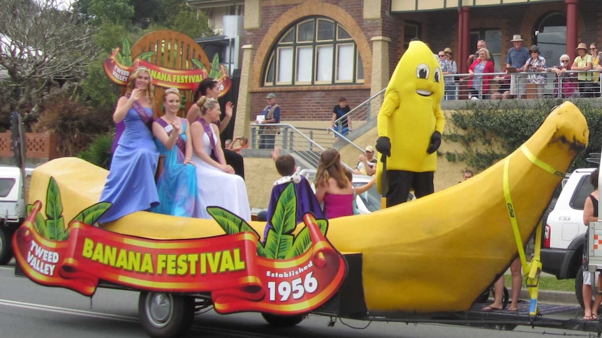 A giant banana float is towed by an SES vehicle