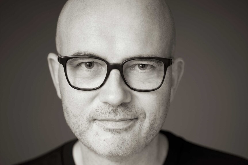 Black and white photo of philosopher Lars Svendsen wearing thick-rimmed black glasses.