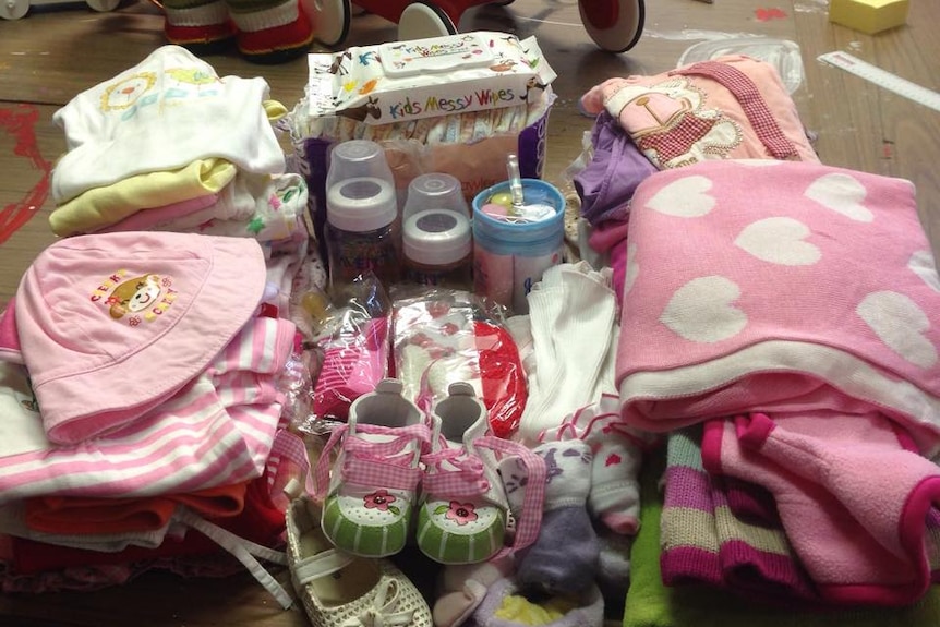 Pink blankets, clothes, nappies and milk bottles make up a girl's package.