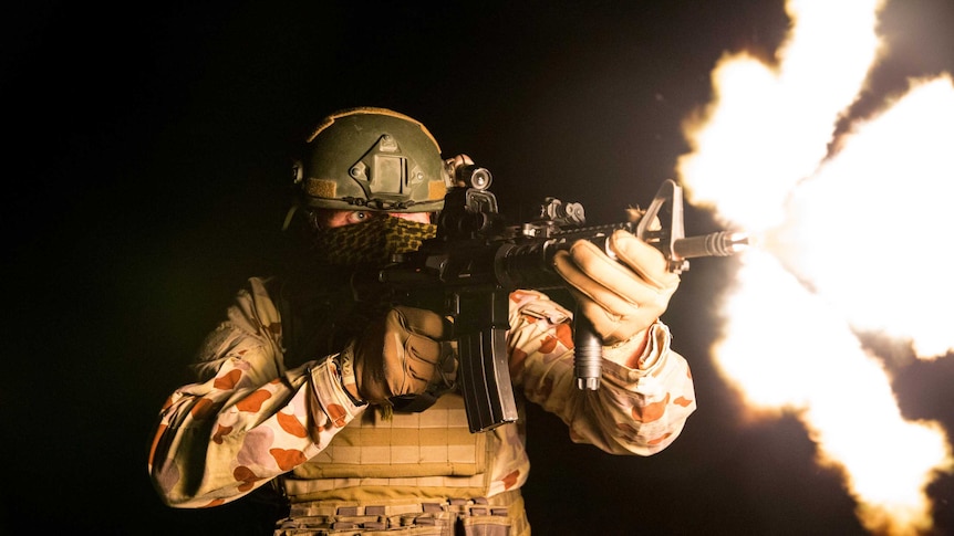 Special forces soldier fires weapon