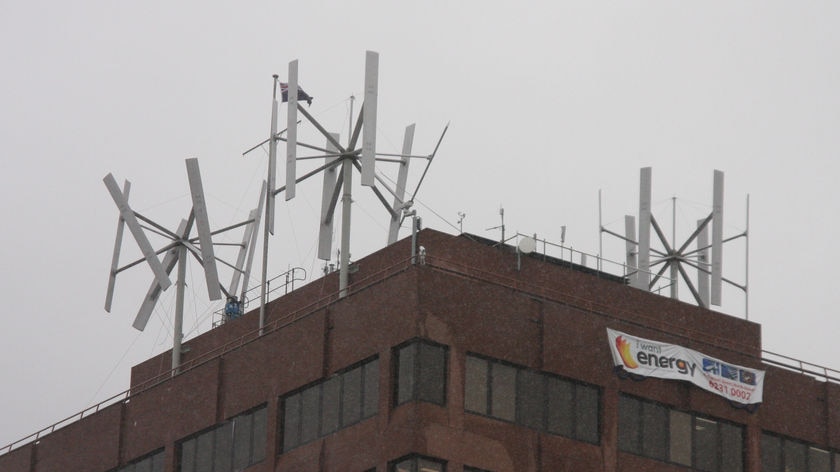 A broken wind turbine (left) on top of Hobart's Marine Board building.
