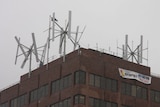 A broken wind turbine (left) on top of Hobart's Marine Board building.