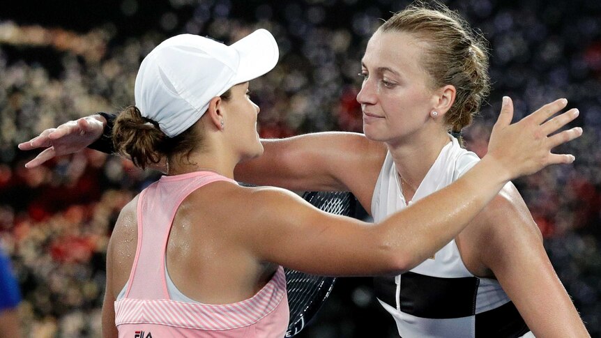 Two players hug at the net after their women's singles quarter-final at the Australian Open.