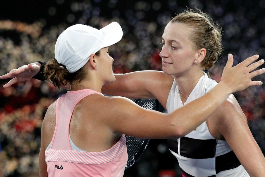 Two players hug at the net after their women's singles quarter-final at the Australian Open.