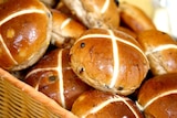 Delicious hot cross buns in a basket.