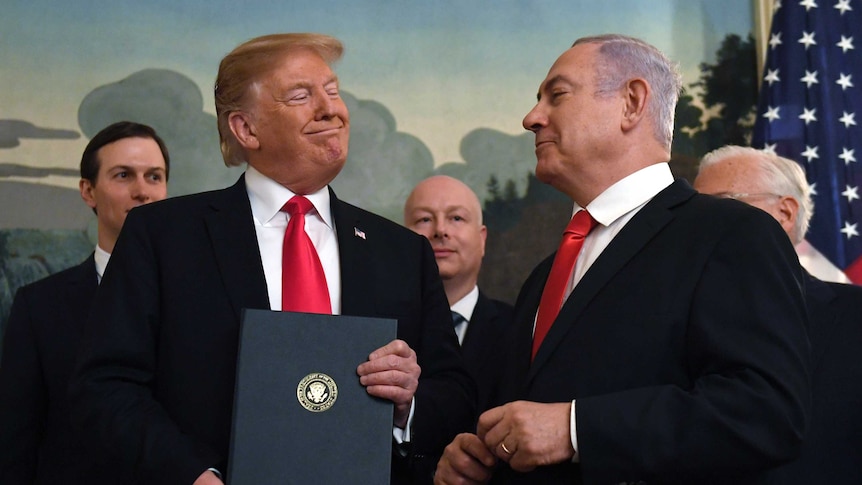 Donald Trump smiles at Benjamin Netanyahu during a function at the White House.