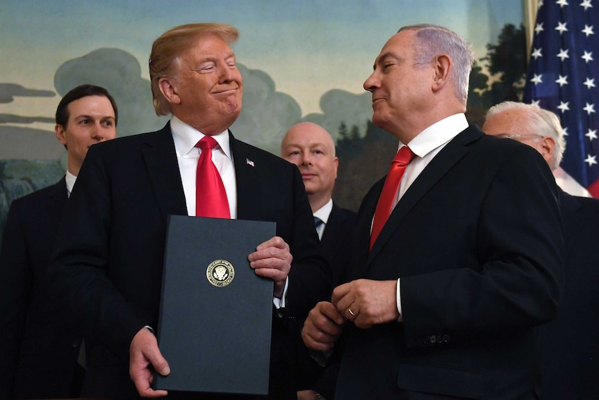 Donald Trump smiles at Benjamin Netanyahu during a function at the White House.