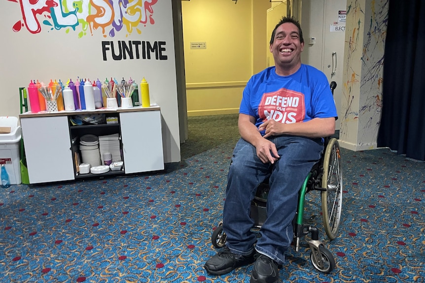 A man sits in a wheelchair.