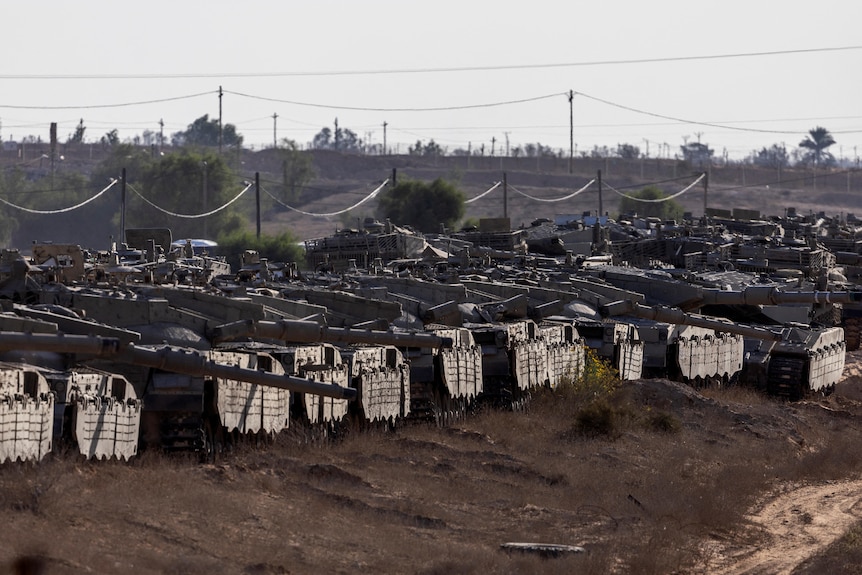 Numerous Israeli tanks are seen gathered in southern Israel.