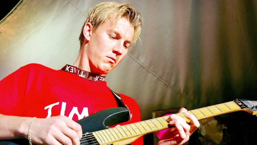 Brett Lee plays guitar