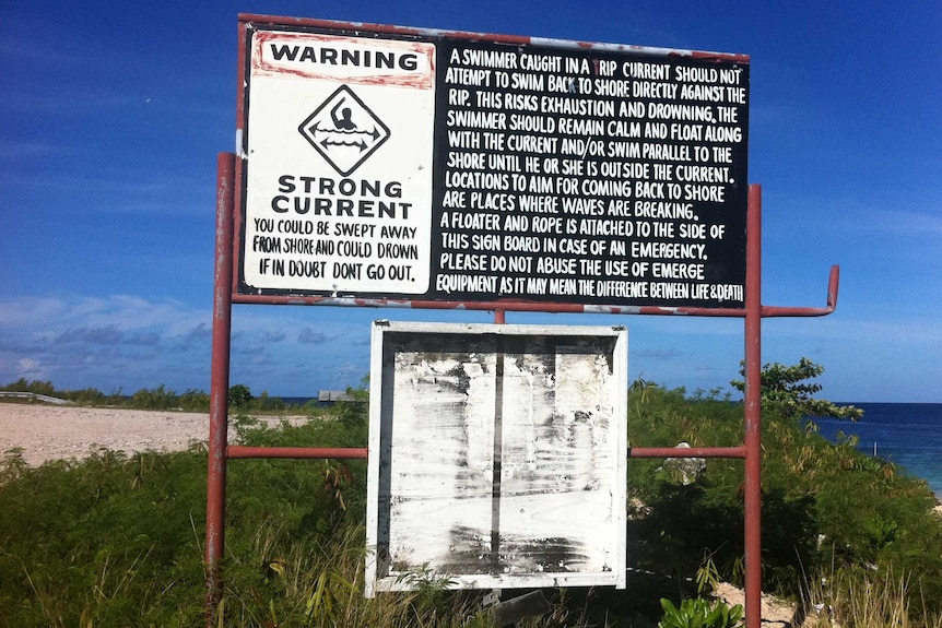 A sign warning swimmers of strong currents is seen on Nauru