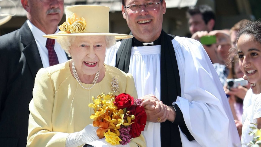 Queen Elizabeth II and Reverend Paul Black leave a service at St John's Church.