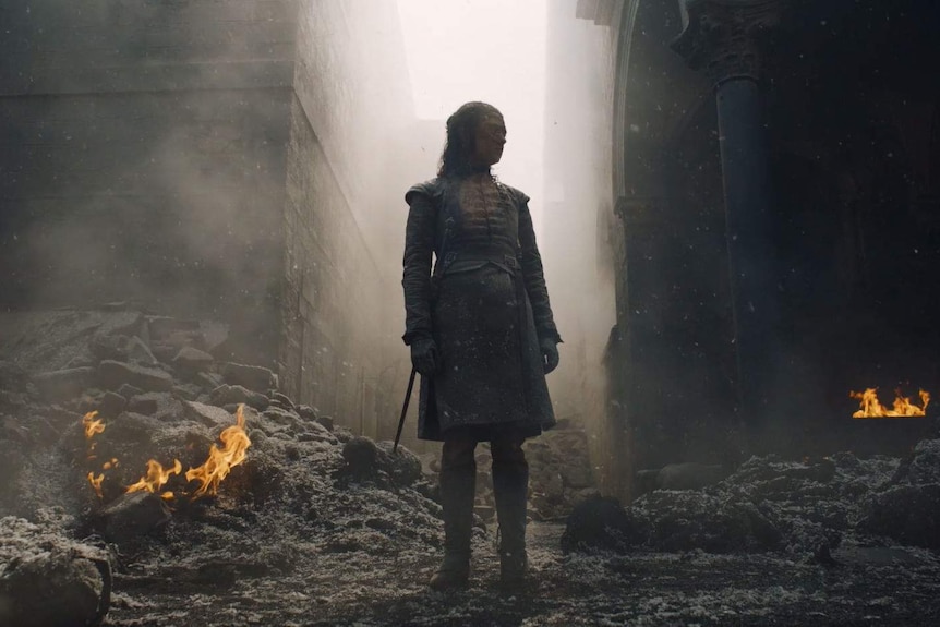 Arya stands in the rubble at King's Landing.