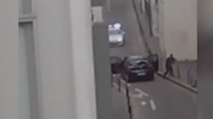 Still of video of gunmen firing at police after leaving offices