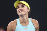 Australian tennis player Arina Rodionova shrugs while holding a tennis racquet.