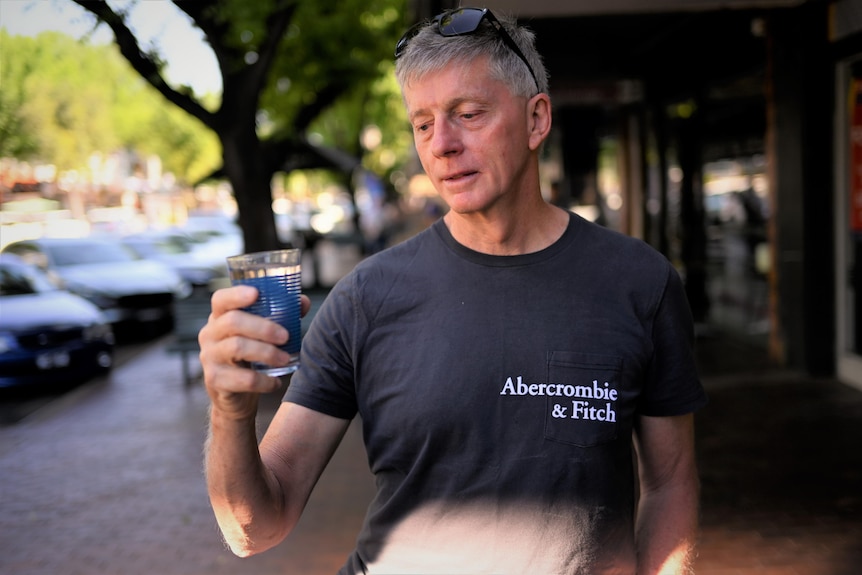 A man with a glass of water